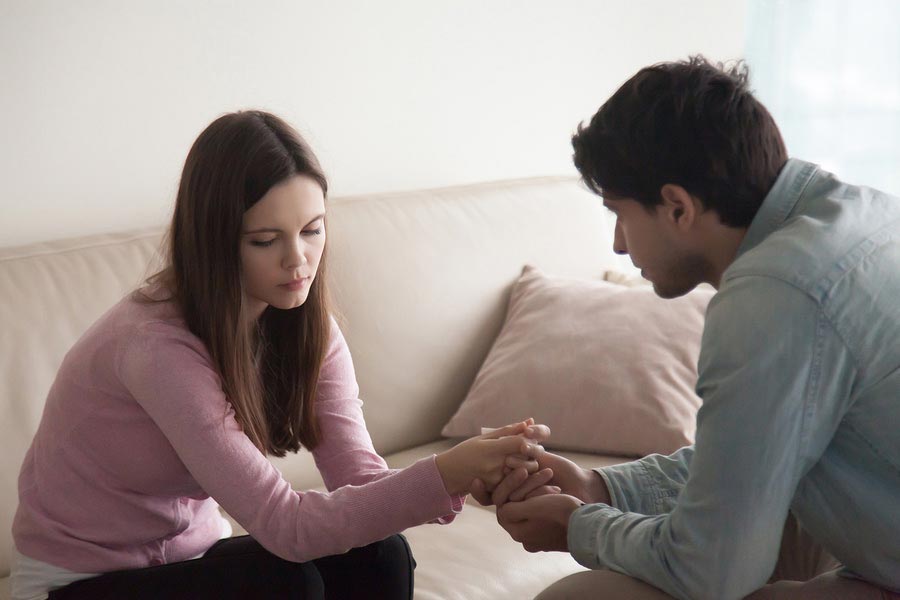 A woman with chronic illness being comforted by her husband or boyfriend.