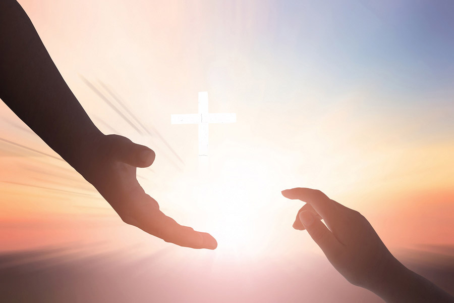 A man reaches for another's hand, indicating that we are all connected with chronic illness and faith.