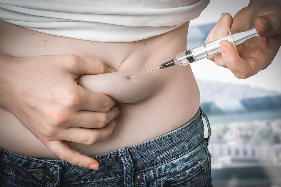 Woman with diabetes giving herself an insulin injection