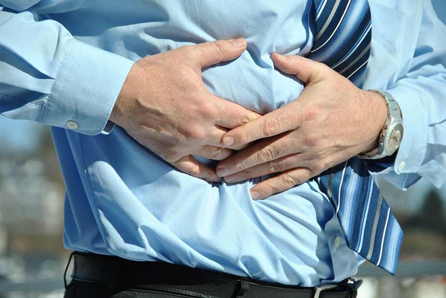 A man coping with the symptoms of IBS