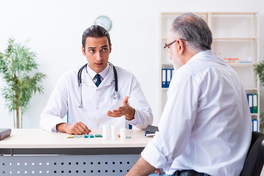 Doctor talking to older man with prostate cancer