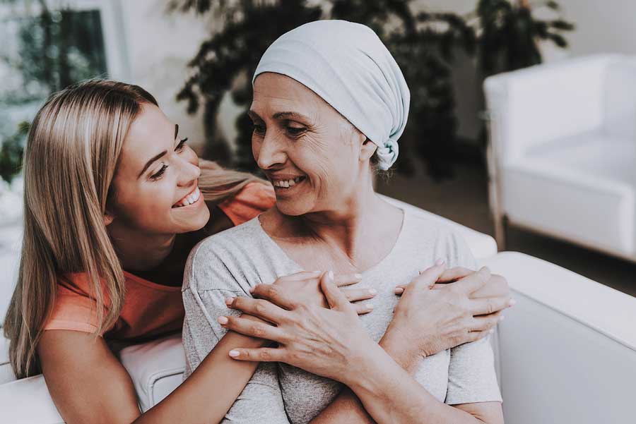 A woman comforts another woman after breast cancer diagnosis