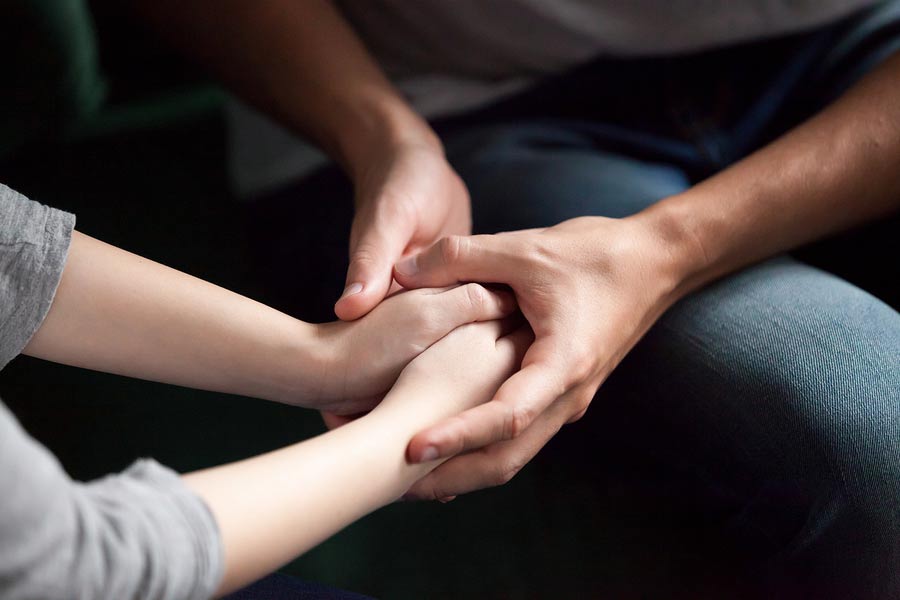 A man comforting a woman with IBD