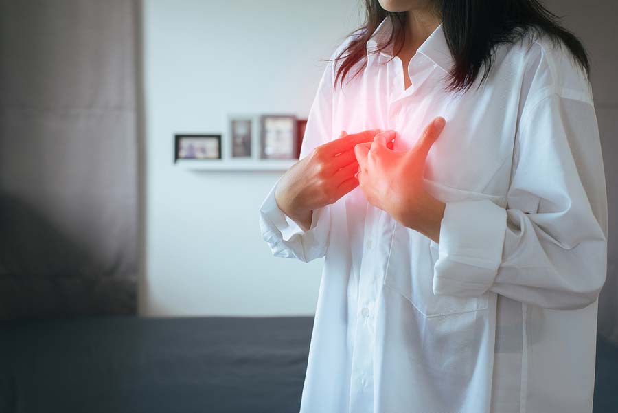 A woman experiencing pain from acid reflux